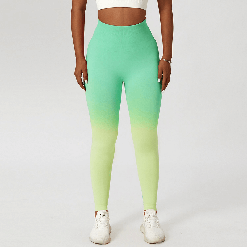 Women's gradient seamless high waist yoga leggings in green, perfect for fitness, running, and sports. Model wears white sneakers.